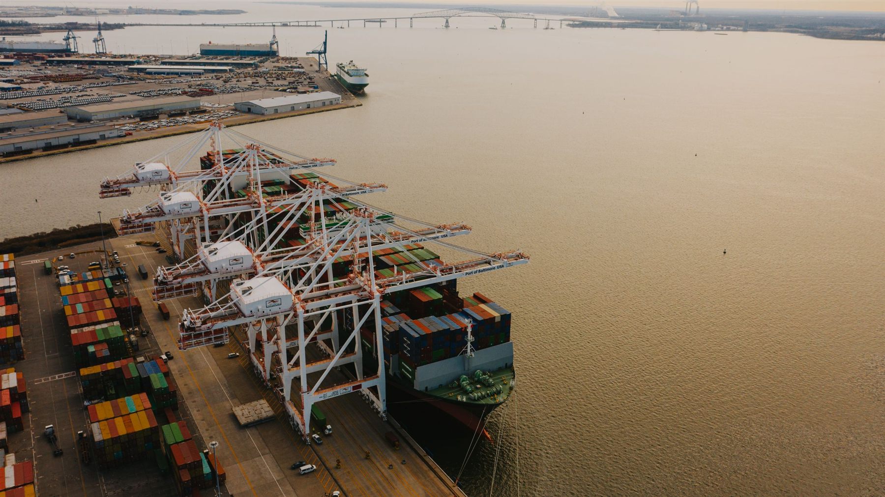 Cranes loading a cargo vessel at a Philippine port